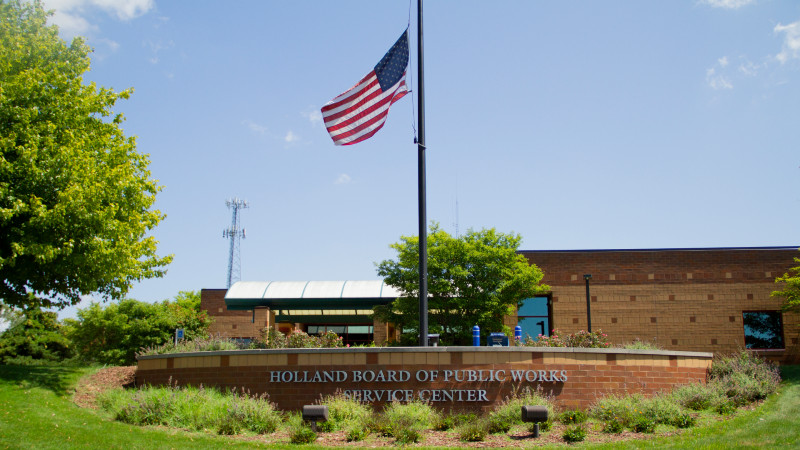 Front sign for BPW Service Center on a sunny day with the American flag flying.