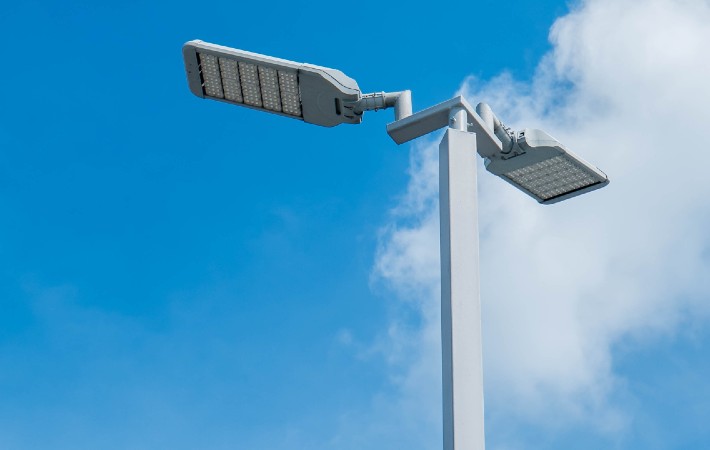 Cobra headed LED streetlight against a blue sky