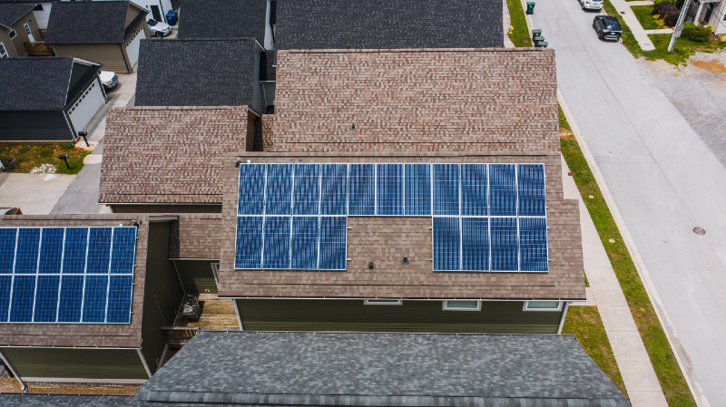 Solar panels installed on a brown residential roof