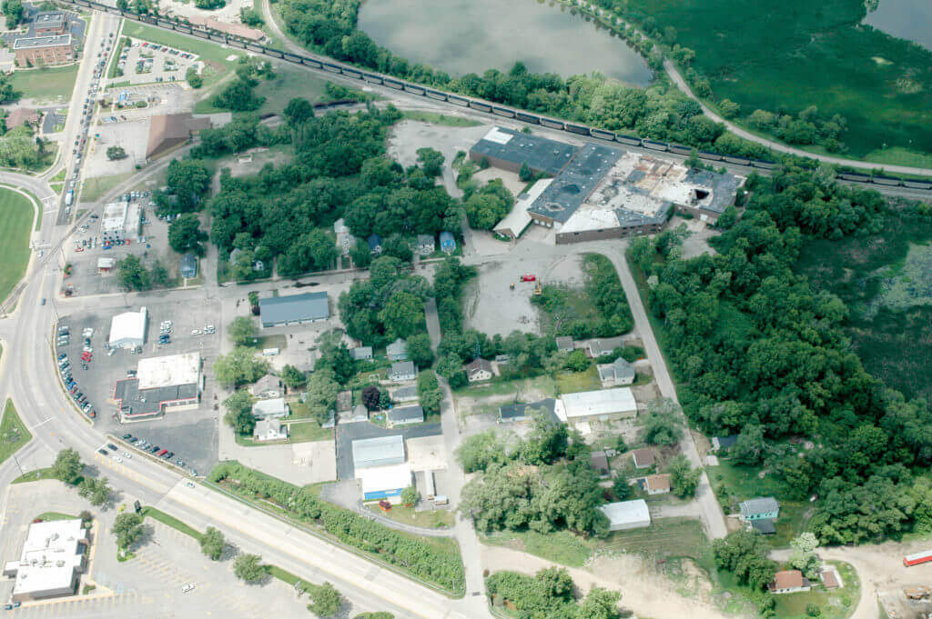 Satellite image of Macatawa watershed along former First street with trees and dilapidated buildings.