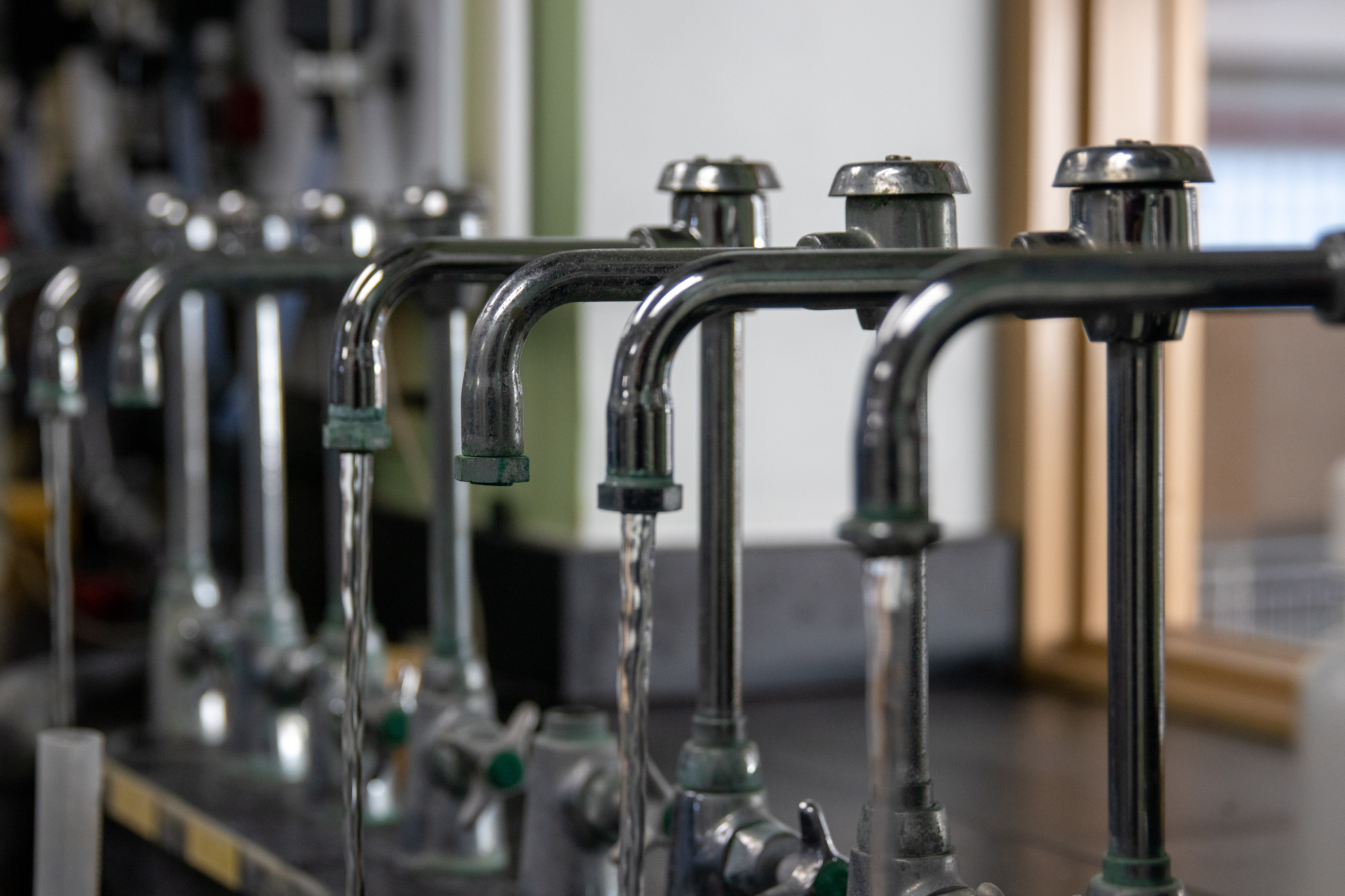 Row of running water taps at the Water Treatment Plant.