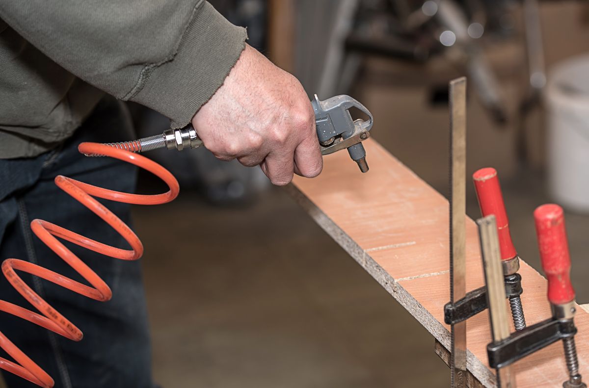 Compressed air cleaning a piece of wood