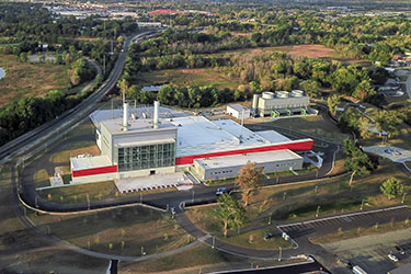 Red power plant with large windows.